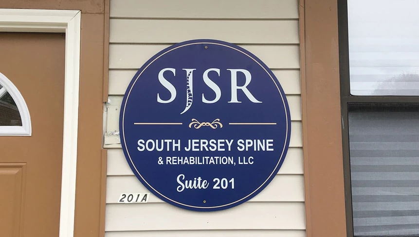 Round aluminum signage with South Jersey Spine and Rehabs logo printed using UV printing.