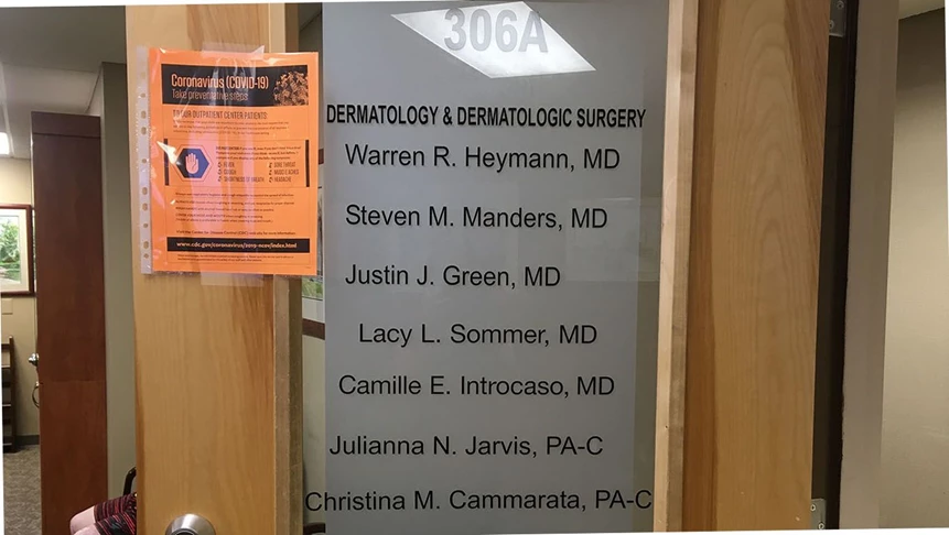 New door graphics for the dermatology office after hiring a new doctor.