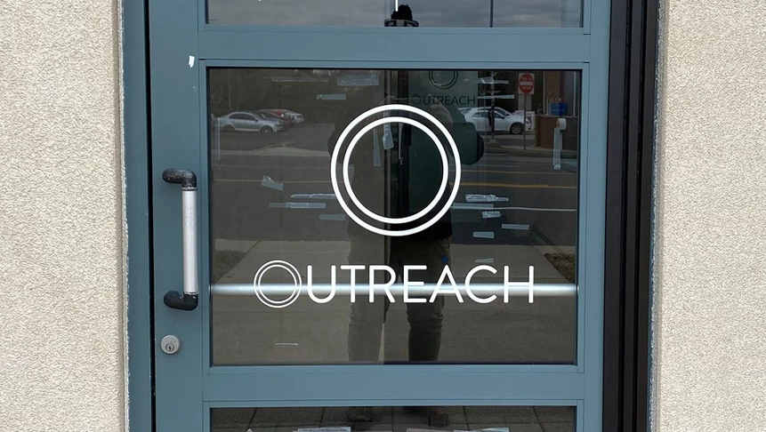 Outreach labeled their entrance door with their minimalist logo.