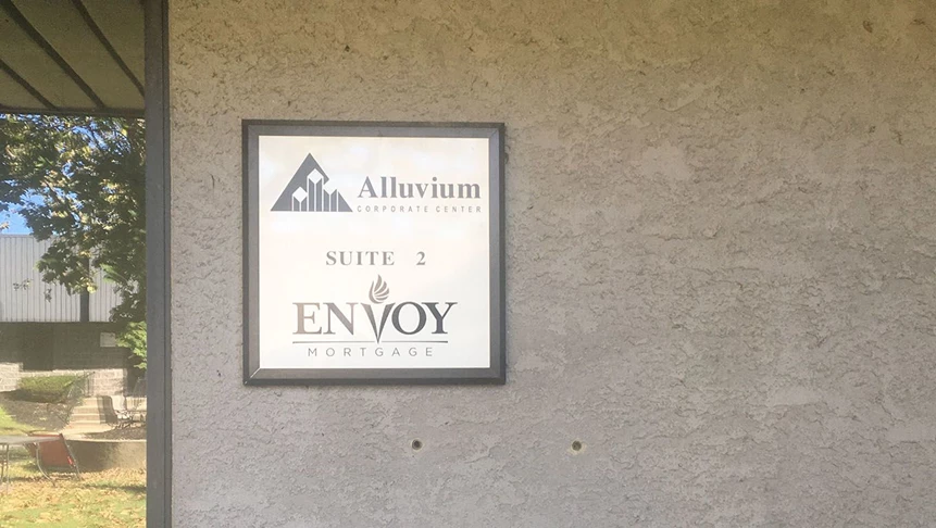 Envoy asked us to cut their logo out of black vinyl to install on the existing metal suite sign.