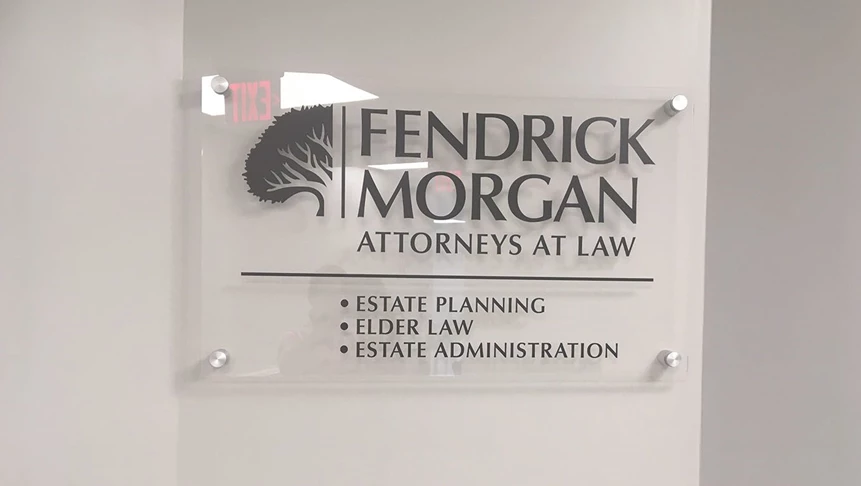 Vinyl placed on clear acrylic for this interior hallway suite signage for Fendrick Morgan.