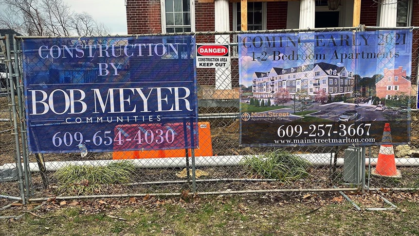 Mesh banners for Bob Meyer Communities. Installed on fencing on Main Street in Marlton.