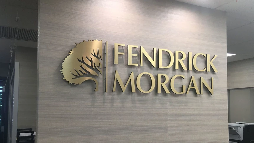 3D lettering made from acrylic with brushed gold aluminum laid overtop, installed in Fendrick Morgans lobby.