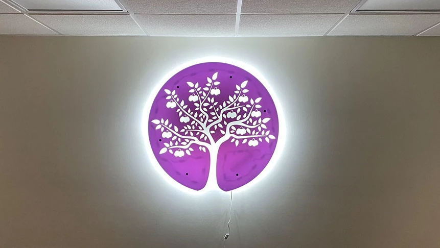 Plum Real Estates logo cut from acrylic and backlit with LED lights.