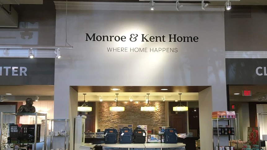 Vinyl lettering on Monroe & Kents façade welcoming their customers.