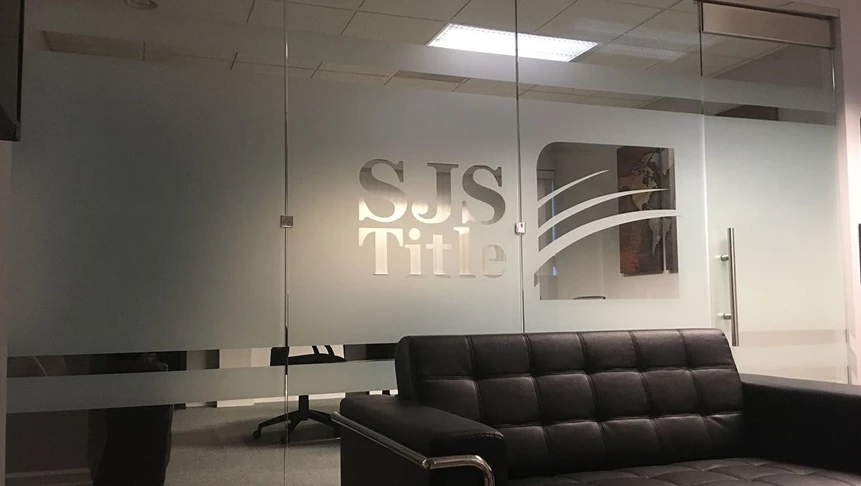 SJS Title wanted to implement their logo within frosted vinyl bands for their conference room.