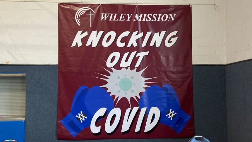 Indoor banner for Wiley Mission while administering the COVID vaccine